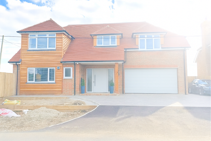 Exterior view of a newly built, detached home in Mersham by Shorter Developments Ltd, showing modern architecture and freshly landscaped surroundings